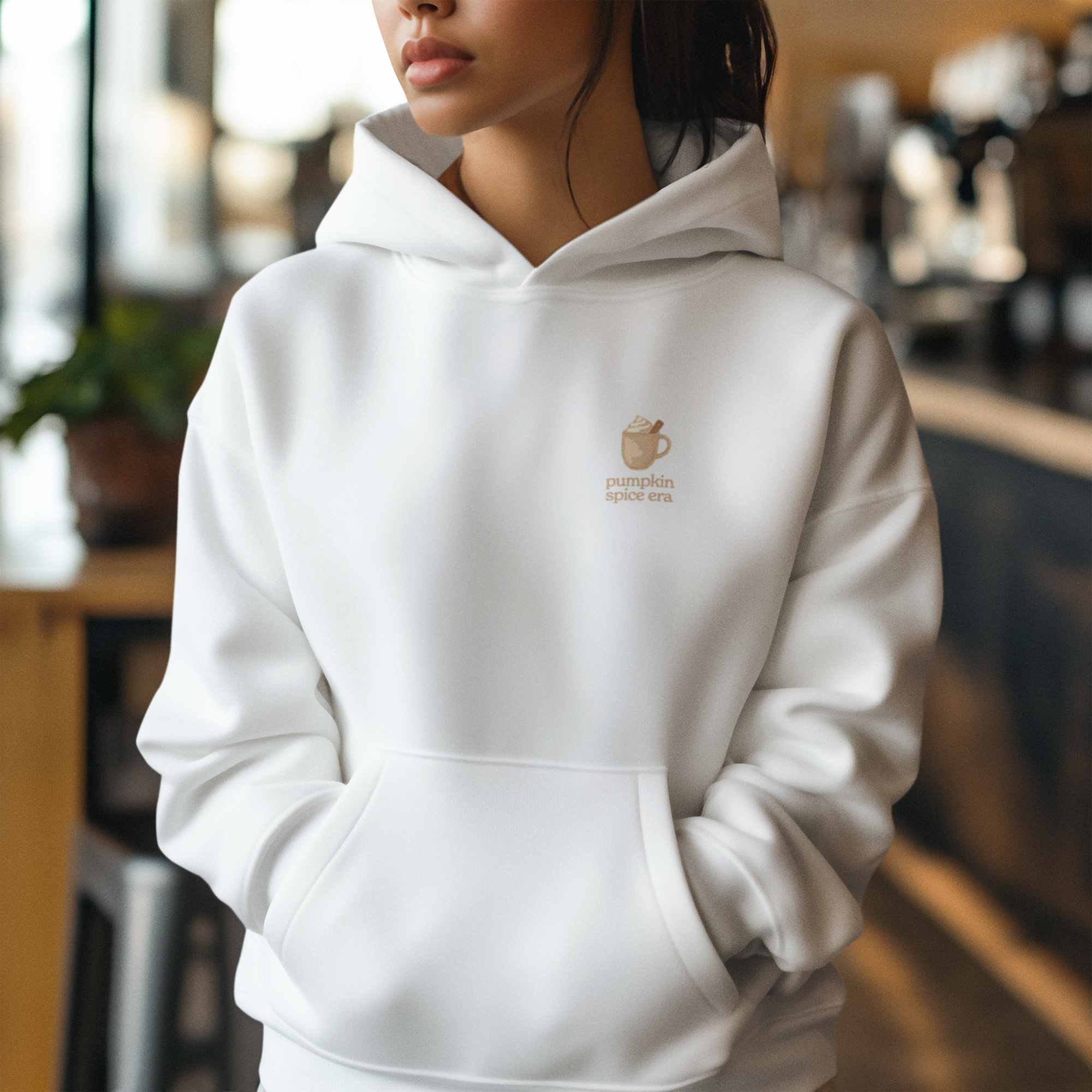 Adult hoodie in white with 'Pumpkin Spice Era' graphic print. Fall & pumpkin themed graphic sweatshirts. 
