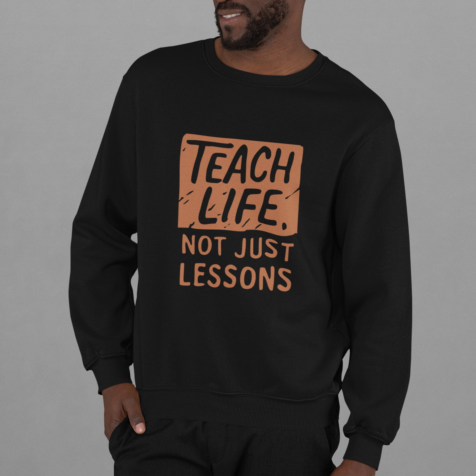 Adult sweatshirt in black with 'Teach Life, Not Just Lessons' graphic print.  Teacher & education themed graphic tees for homeschoolers.
