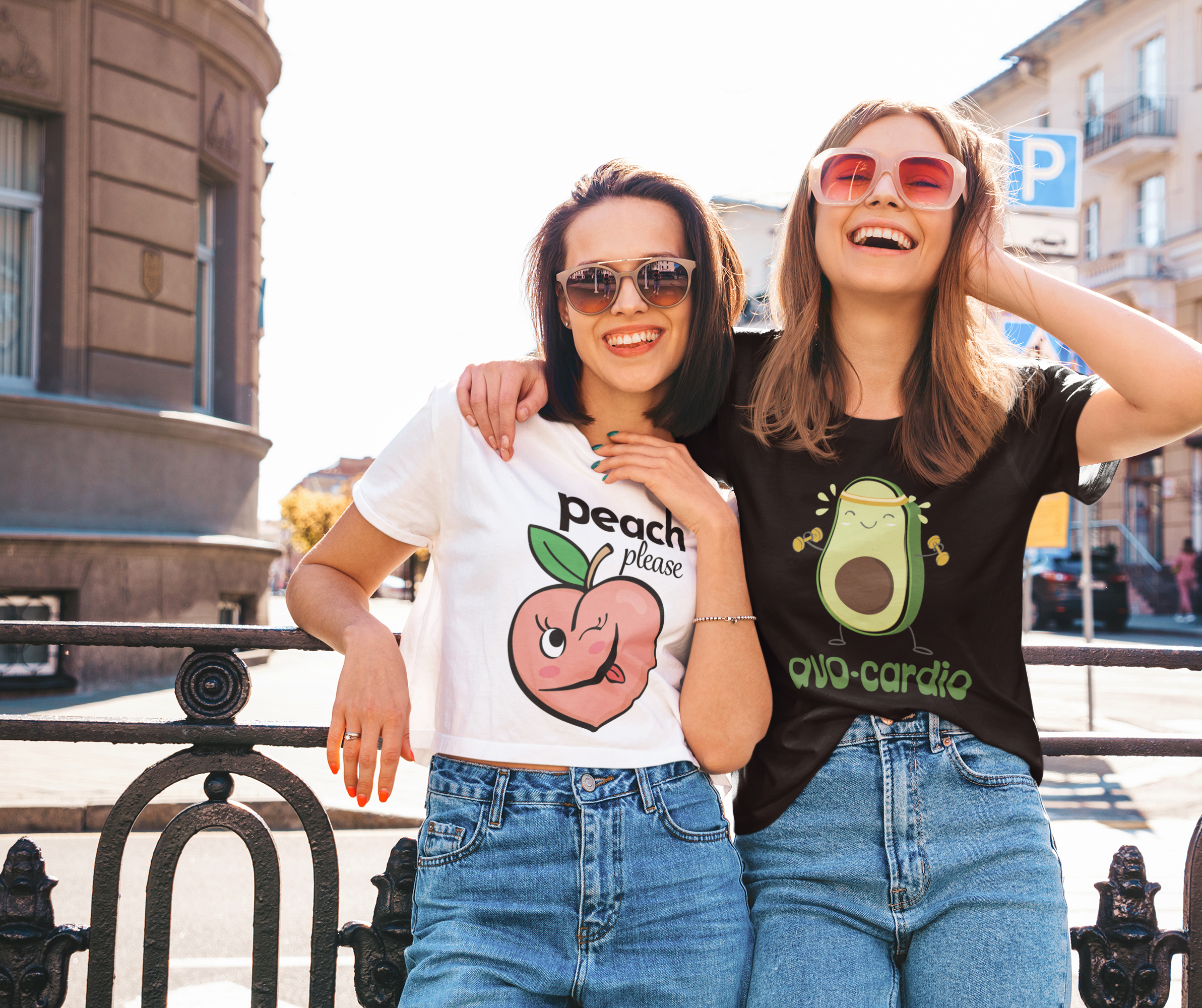 Two women wearing ctrl ink's bold graphic t-shirts of different styles on a city street.